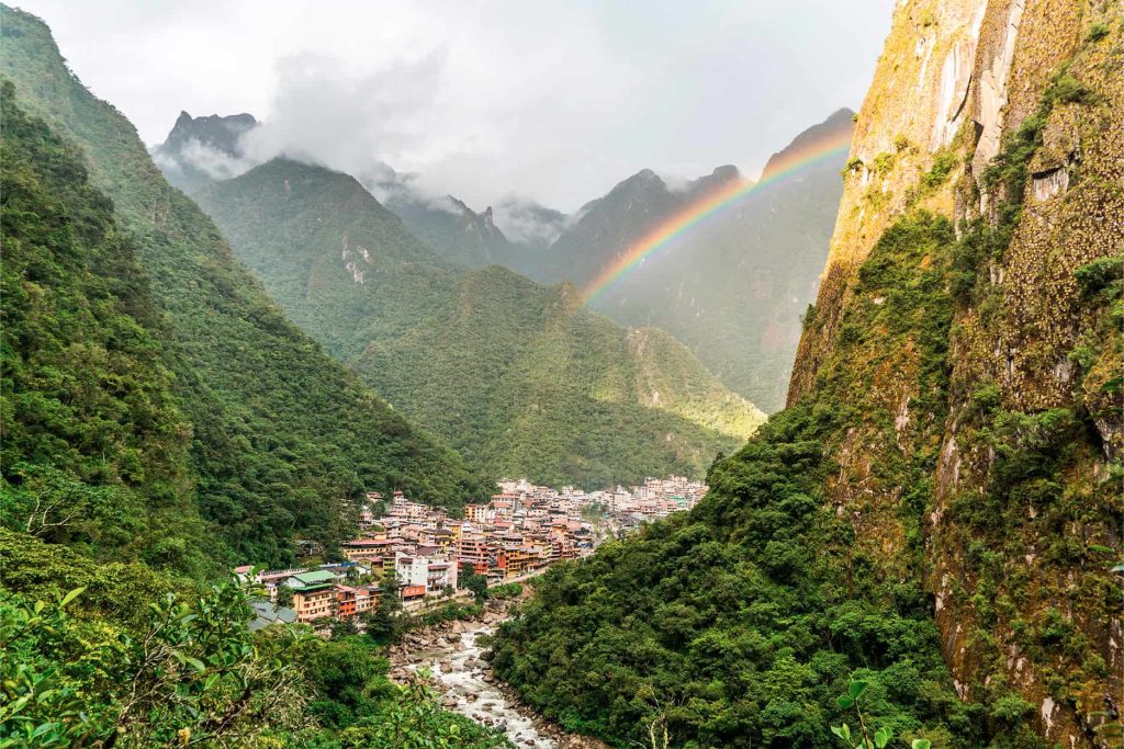A rainbow arches over Aguas Calientes, the gateway to Machu Picchu, Peru.