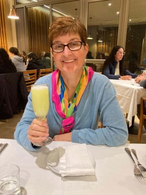 Best food in Latin America Pia from Viva holding a glass of pisco sour