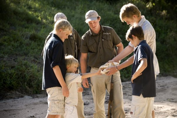 Family group looking at fossil Family group looking at fossil