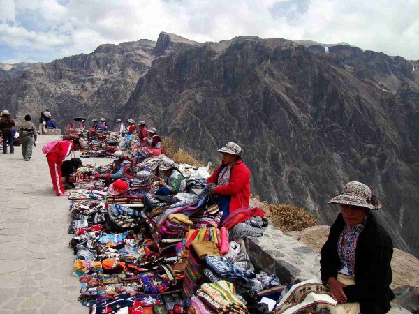 Culture of South America women sell colourful textiles Culture of South America women sell colourful textiles