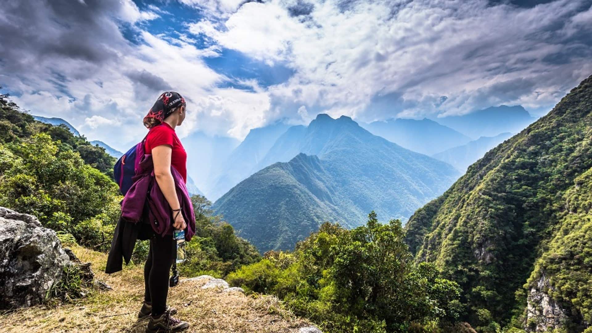 Women trekking through the rugged mountains of Peru surrounded by breathtaking landscapes and towering peaks.